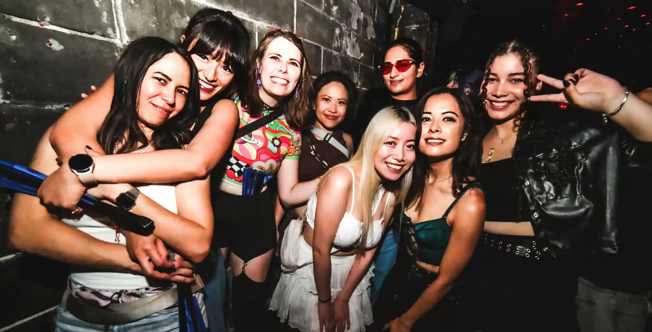 Group of diverse queer women celebrating at Vancouver Pride 2026 event.