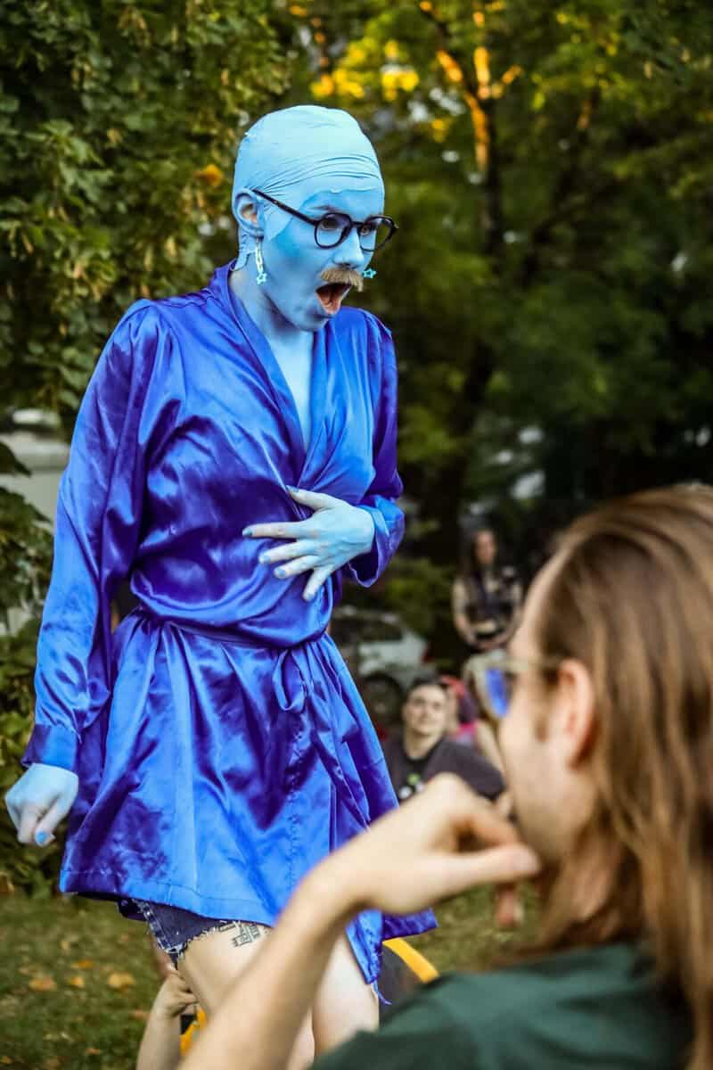 Performer in blue costume and makeup at Vancouver Trans March event.
