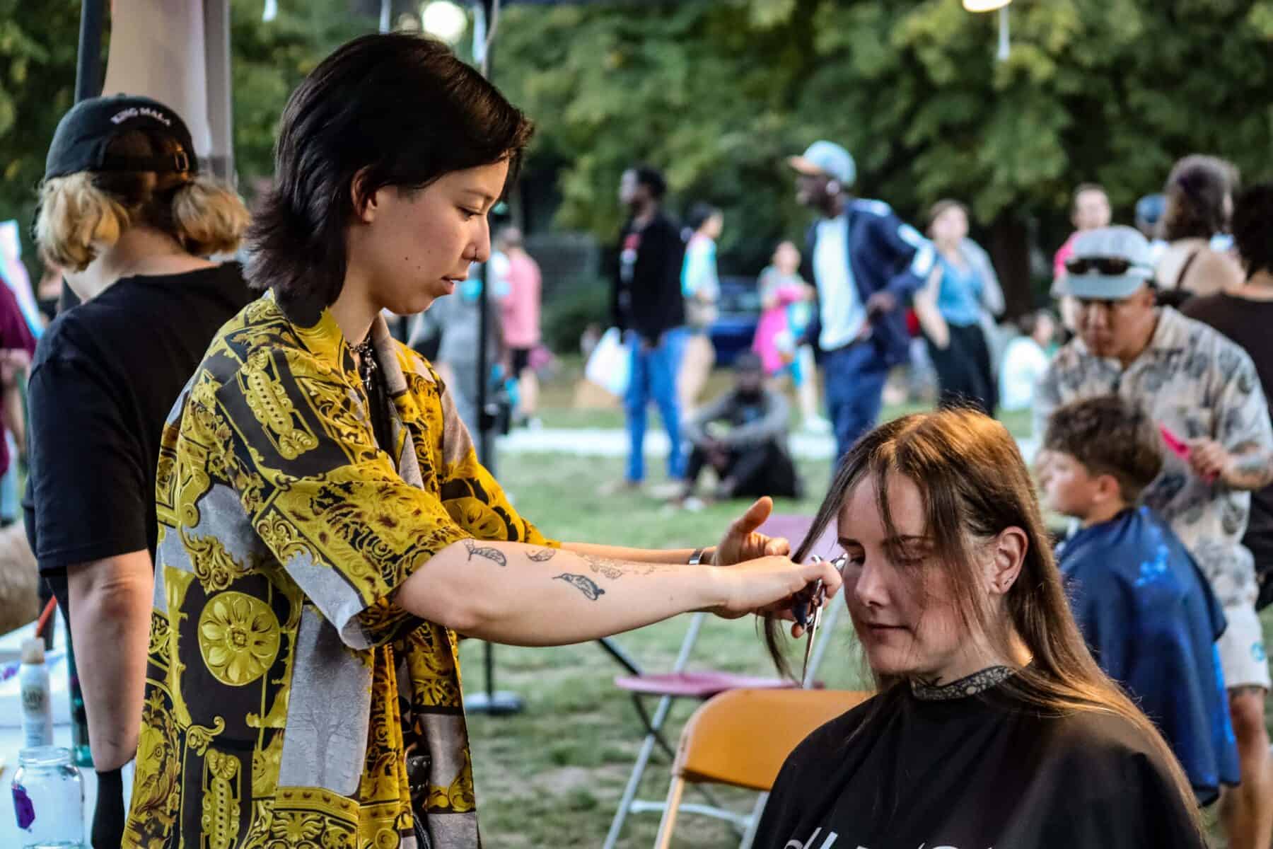 Trans March participant getting makeup applied at Vancouver event.