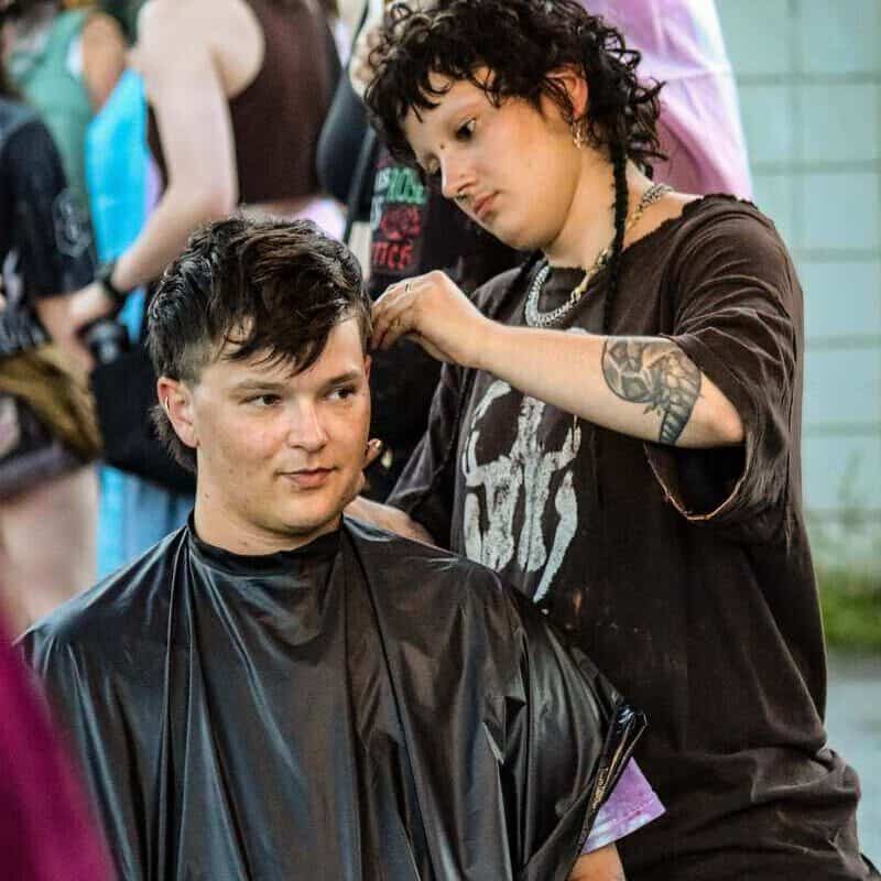 Transgender person getting a haircut at Vancouver Trans March event.