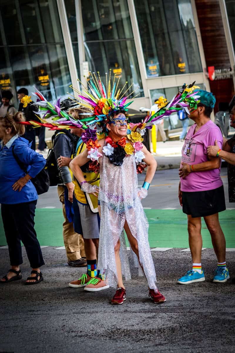 Colorful parade costume with feathers and sequins at Now Canada event.