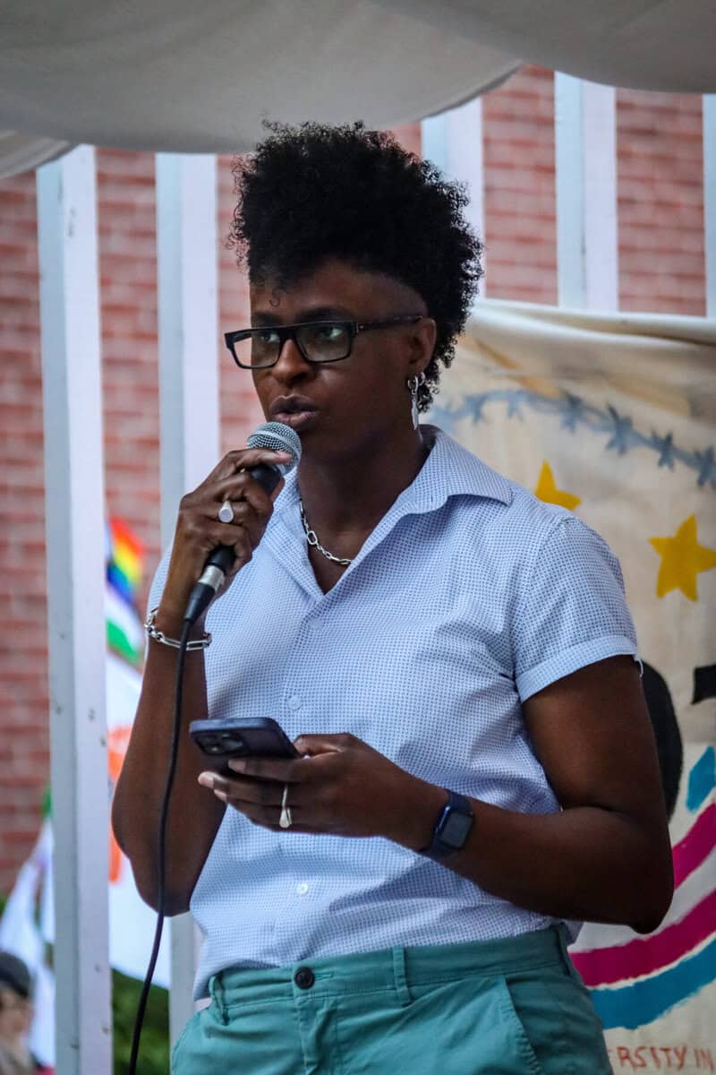 Queer speaker at Ottawa Trans March speaking into microphone.